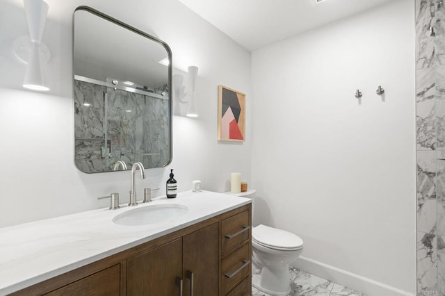 bathroom featuring a marble finish shower, baseboards, toilet, marble finish floor, and vanity