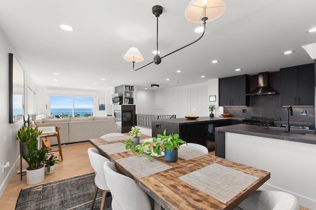 dining space with recessed lighting and a glass covered fireplace