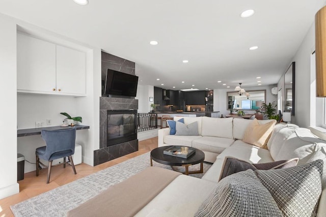 living area with recessed lighting and a fireplace