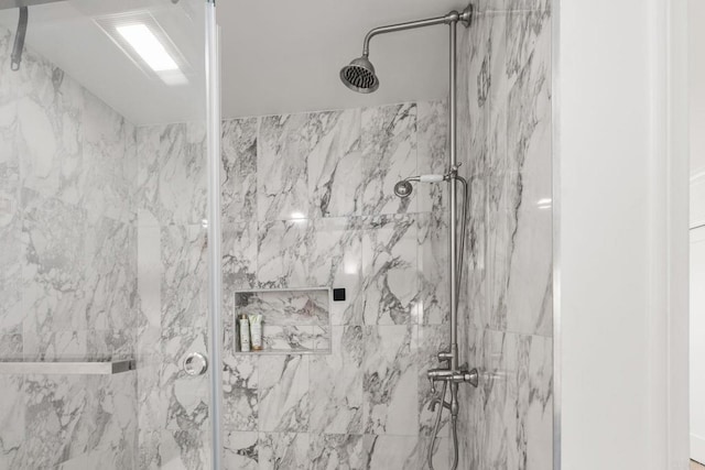 full bathroom with a marble finish shower