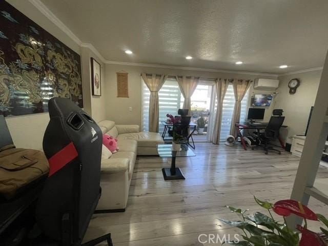 living room with recessed lighting, a wall mounted air conditioner, light wood-style flooring, and crown molding