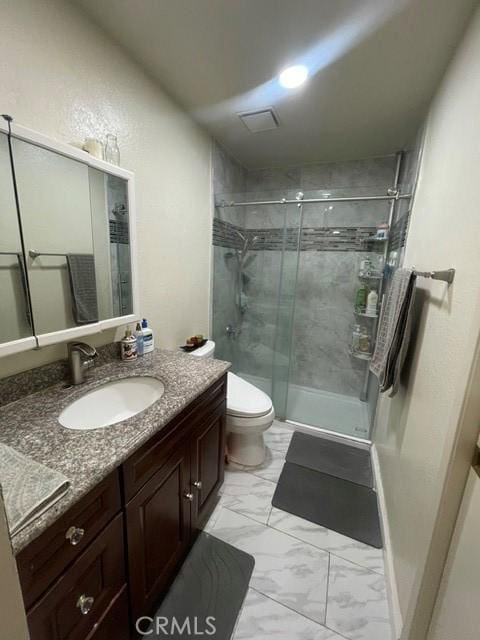 bathroom with a stall shower, marble finish floor, vanity, and toilet