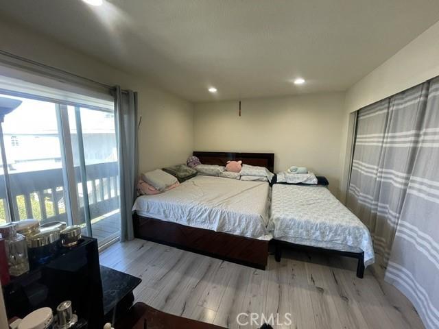 bedroom with wood finished floors and recessed lighting