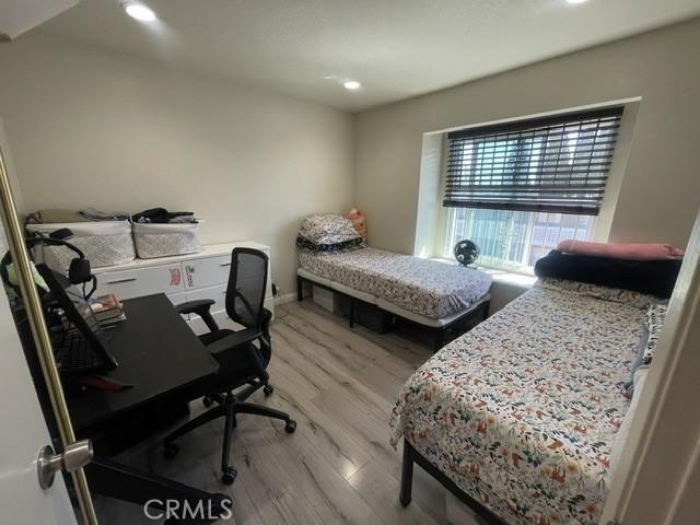 bedroom featuring recessed lighting, baseboards, and wood finished floors