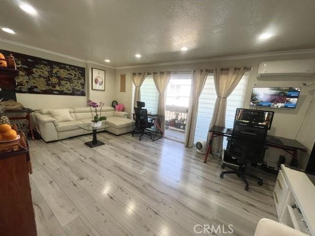 living area featuring light wood-style flooring, a textured ceiling, crown molding, an AC wall unit, and recessed lighting