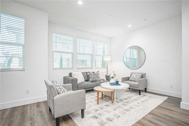 living area featuring recessed lighting, wood finished floors, and baseboards