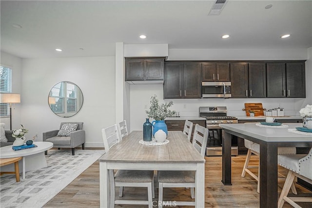 kitchen featuring light wood finished floors, appliances with stainless steel finishes, visible vents, and recessed lighting