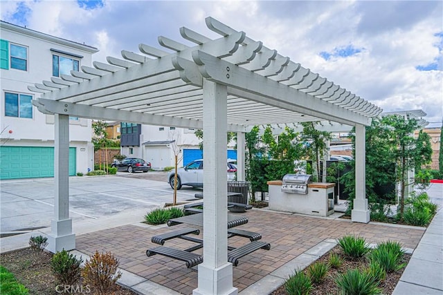 view of patio / terrace featuring grilling area, an outdoor kitchen, and a pergola