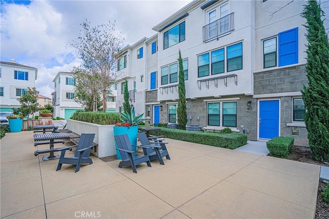 view of home's community featuring a residential view and a patio area