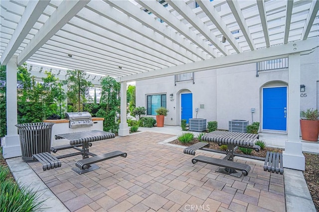 view of patio featuring a grill, area for grilling, and a pergola