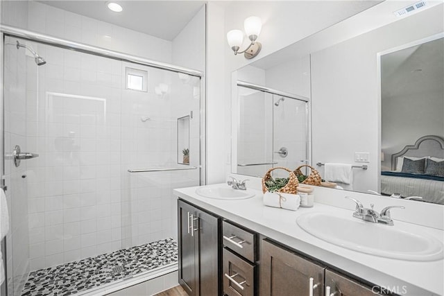 ensuite bathroom featuring ensuite bath, a sink, visible vents, and a stall shower