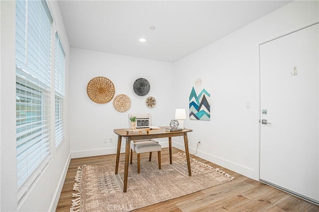 office space with baseboards, wood finished floors, and recessed lighting