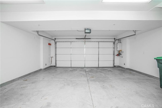 garage featuring a garage door opener and baseboards