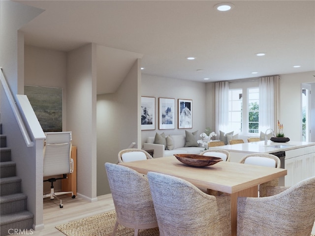 dining space featuring light wood finished floors, stairway, and recessed lighting