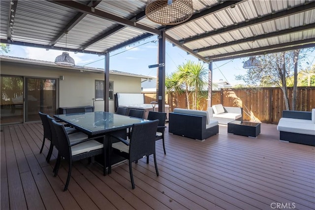 deck featuring an outdoor living space with a fire pit, outdoor dining space, and fence