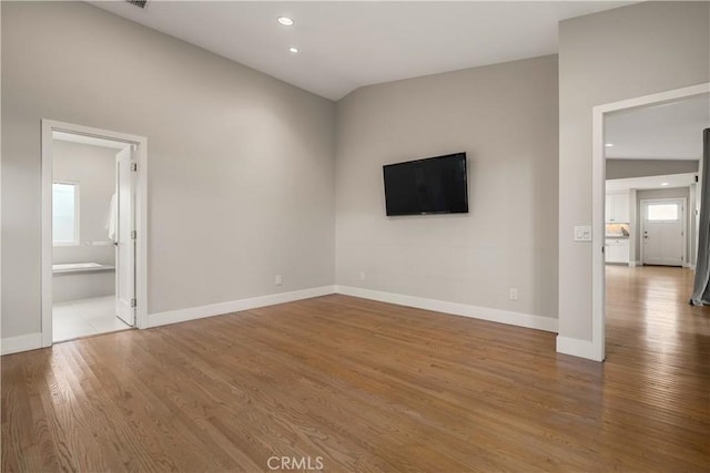 unfurnished living room featuring recessed lighting, baseboards, and wood finished floors