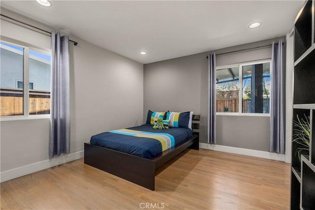 bedroom with recessed lighting, baseboards, and wood finished floors