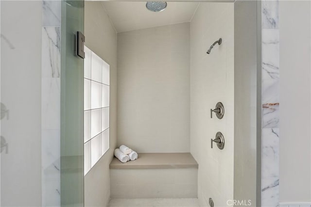 bathroom with a tile shower