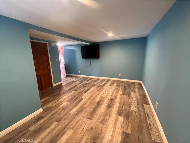 finished below grade area with wood finished floors and baseboards