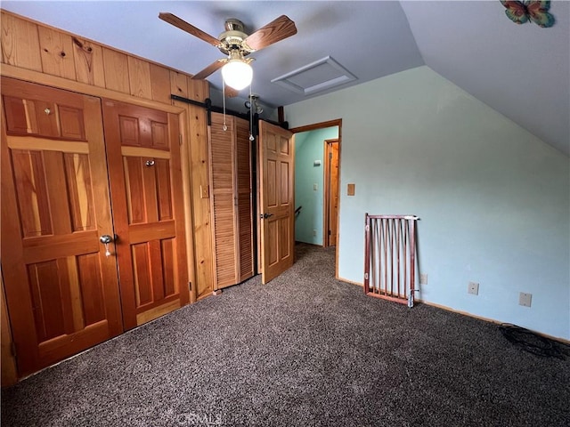 additional living space with vaulted ceiling, carpet, and attic access