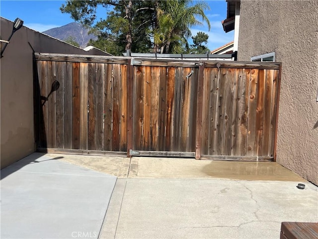 view of gate with a patio area and fence