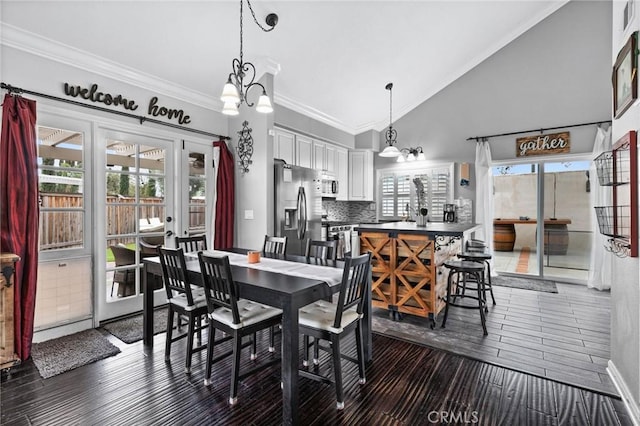 dining area featuring a wealth of natural light, wood finished floors, and ornamental molding