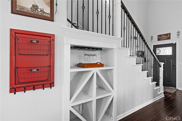 stairs with baseboards and wood finished floors