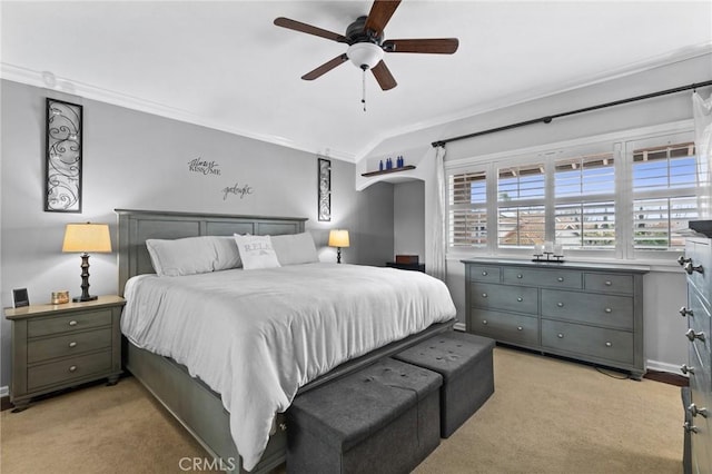 bedroom with vaulted ceiling, ornamental molding, a ceiling fan, and light carpet