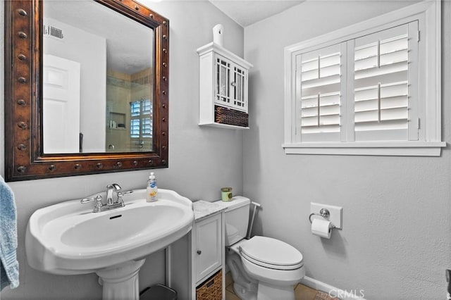 bathroom with a sink, visible vents, and toilet