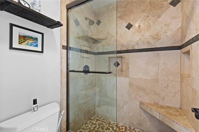 full bath with toilet and a stall shower