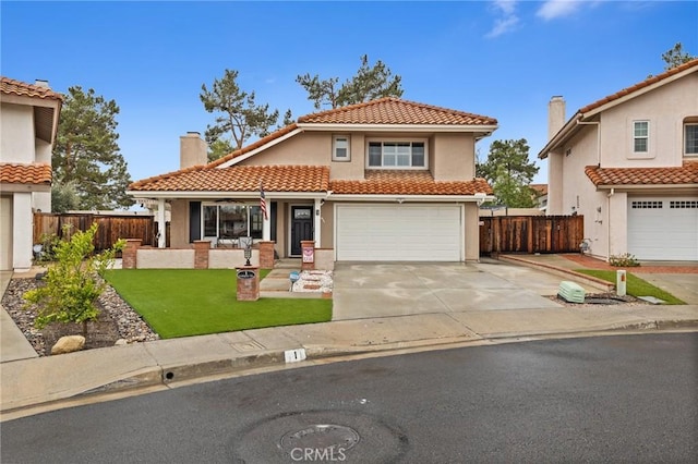 mediterranean / spanish house featuring stucco siding, driveway, fence, a chimney, and a tiled roof