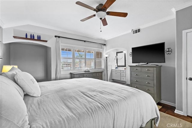 bedroom with visible vents, baseboards, crown molding, and dark wood-type flooring