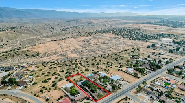 birds eye view of property with a mountain view and a desert view