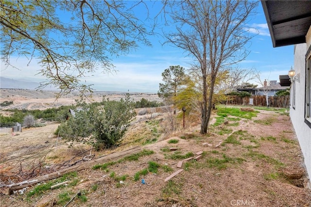 view of yard with fence and a mountain view