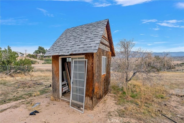 view of shed with fence