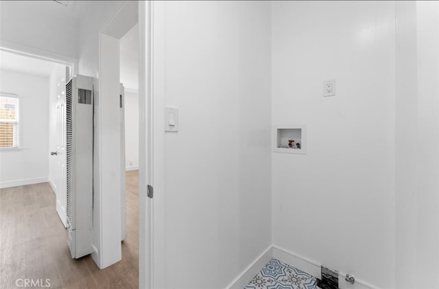 clothes washing area featuring hookup for a washing machine, baseboards, laundry area, and wood finished floors