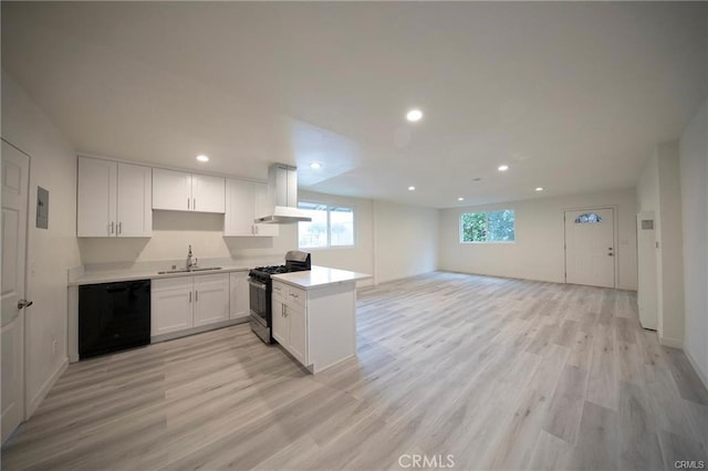 kitchen with a sink, stainless steel gas range, dishwasher, a peninsula, and exhaust hood