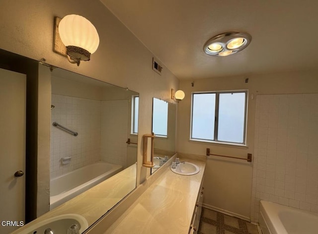 bathroom featuring vanity, visible vents, and shower / bath combination