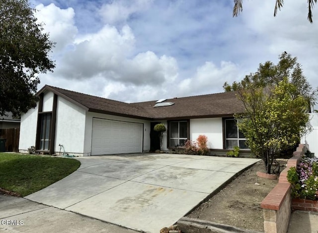 single story home with stucco siding, concrete driveway, an attached garage, and a shingled roof