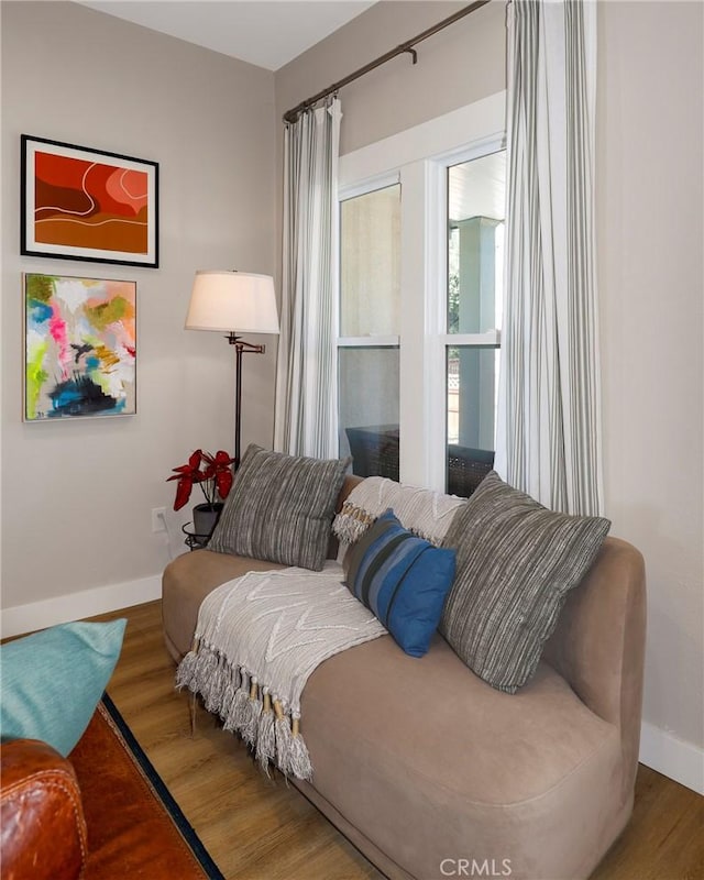 living area with wood finished floors and baseboards