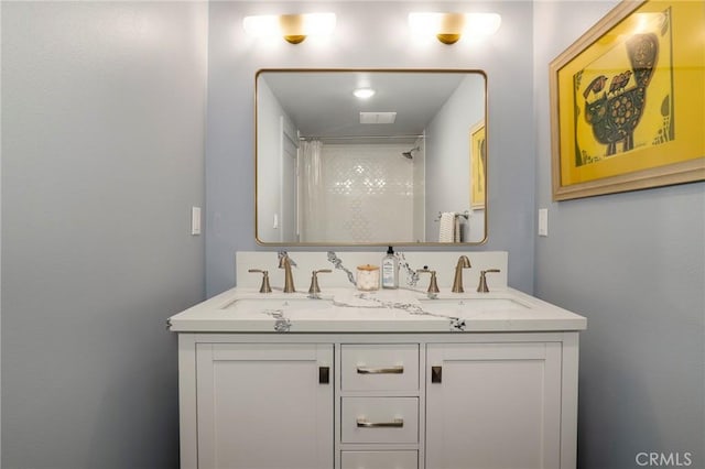 bathroom featuring double vanity, visible vents, walk in shower, and a sink