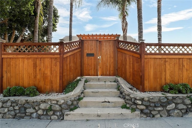 view of gate with fence