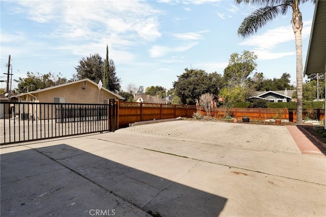 view of patio with a gate and fence