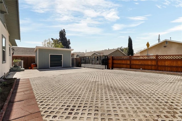 exterior space featuring an outbuilding, fence, and a patio