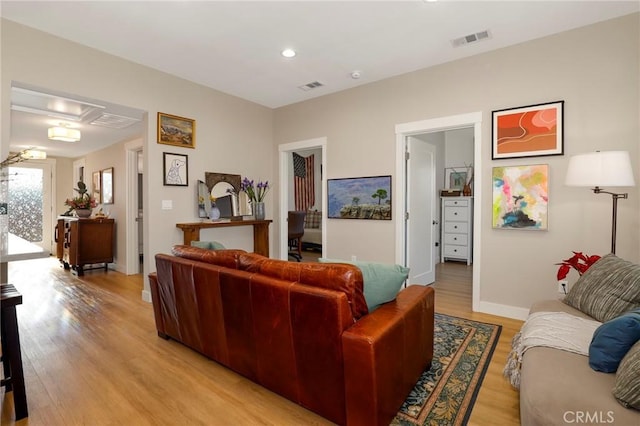 living room with light wood-style floors, recessed lighting, visible vents, and baseboards