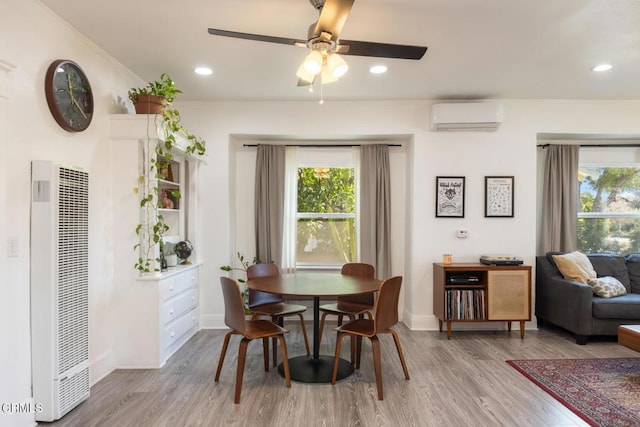 dining room featuring ornamental molding, a heating unit, plenty of natural light, and a wall mounted AC