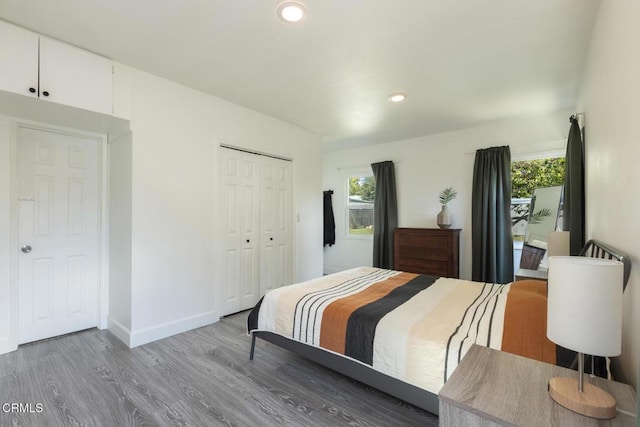 bedroom featuring recessed lighting, multiple windows, and wood finished floors