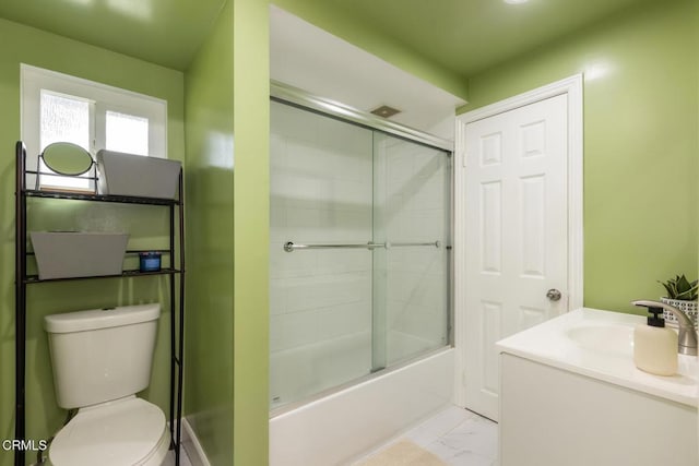 bathroom with enclosed tub / shower combo, marble finish floor, vanity, and toilet