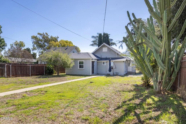 view of front of home featuring a front lawn and fence