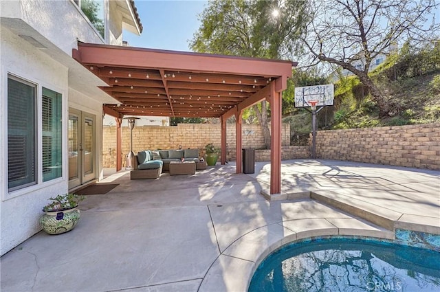 view of patio featuring a fenced backyard, an outdoor living space, and french doors